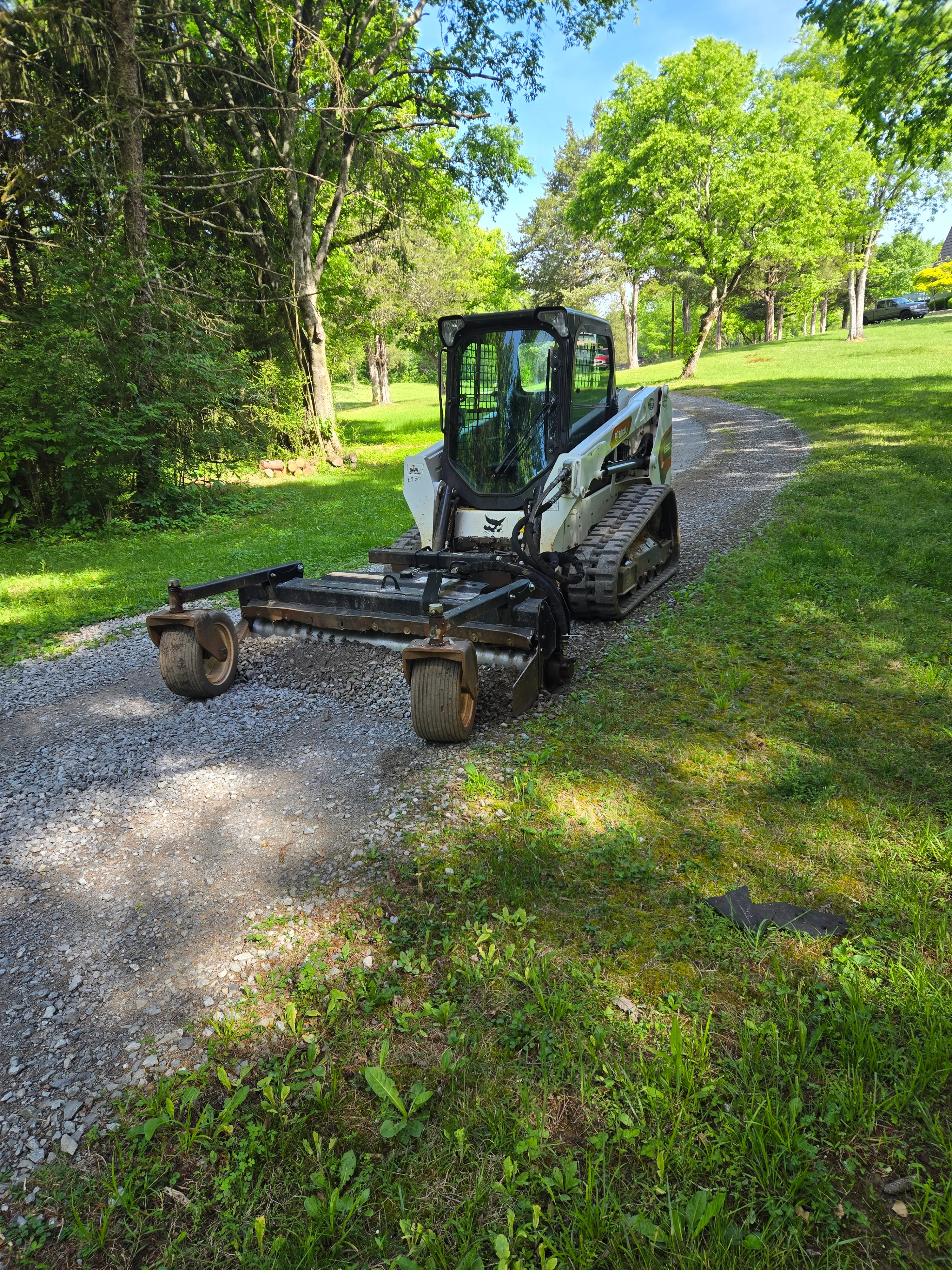 Skid steer working a graded surface on a Maryville, Tennessee property
